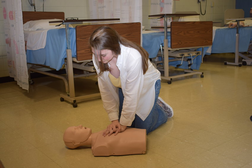Katelyn Lewis demonstrates proper CPR proceedures she learned in certification last week.